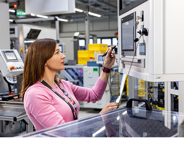 An Associate working on a machine in production.